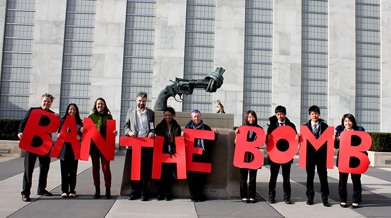 Activists holding up letters spelling out "Ban the Bomb"