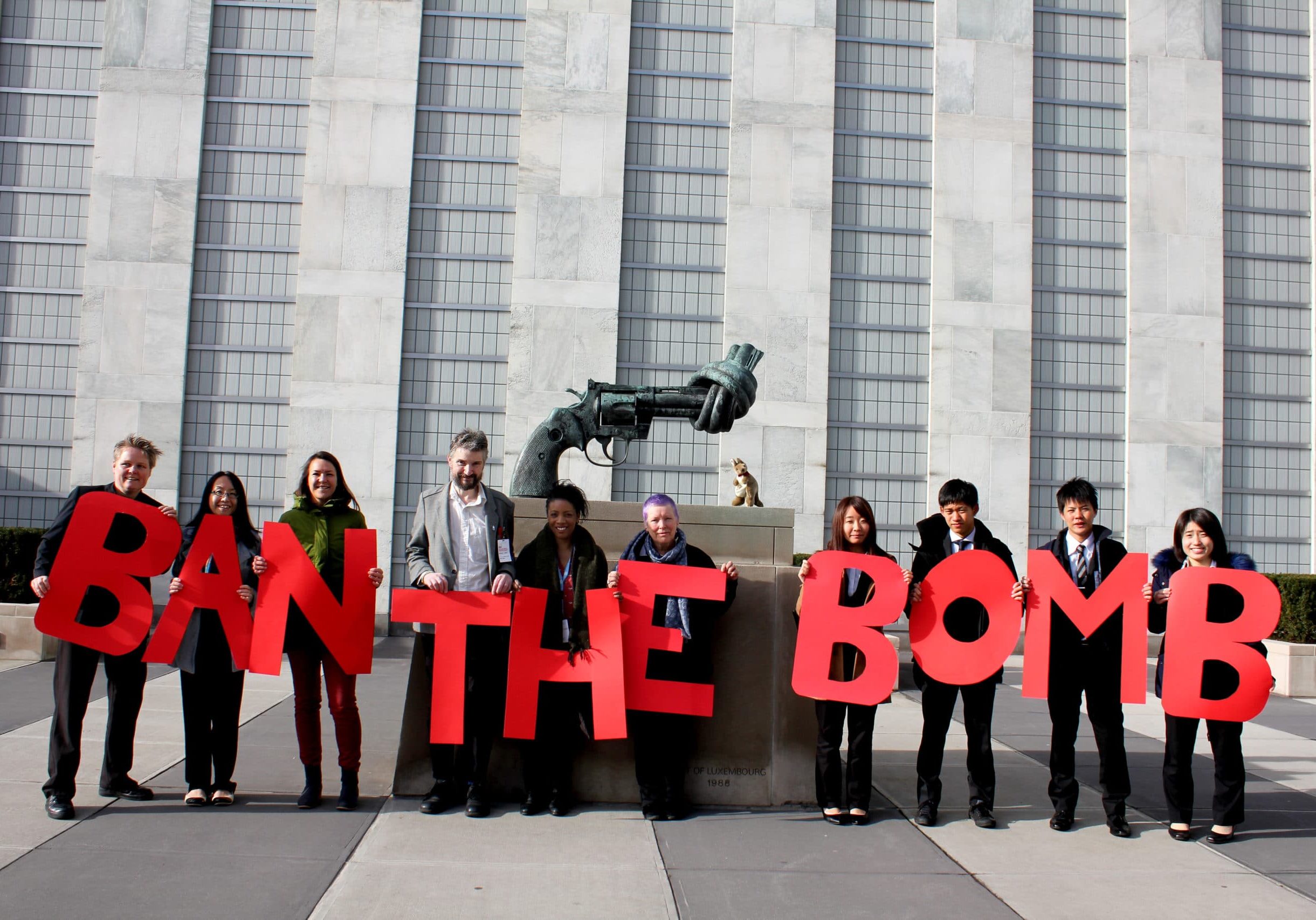 ICAN members holding Ban the Bomb sign at the United Nations